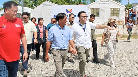 PRESIDENT Ferdinand R. Marcos Jr., joined by DHSUD Secretary Jose Ramon Aliling (right), inspects Cebu’s first Bayanihan Village, underscoring the government’s push to provide safe housing and essential services for families displaced by the earthquake.