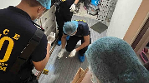 Officers of the Quezon City Police District collecting evidence from the house of Pia and Christian Panganiban, the two suspects involved in the killing of Dianne Marie Mollenido and her son, in Novaliches, Quezon City on Thursday.