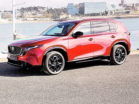 SHOWN by the waterfront, the Mazda CX-5 carries the updates that anchor the company’s new cost strategy.