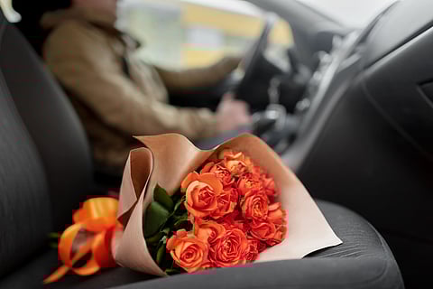 ROSES rest on the passenger seat as a driver heads out to deliver a Valentine’s surprise.