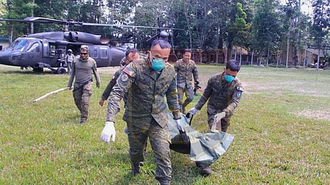 MEMBERS of the military carry the remains of the rebel who was killed in a clash at the hinterlands of Sitio Tacocon in Surigao del Sur.