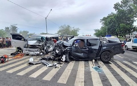 A private commuter van and a pick-up truck lie damaged after a head-on collision along the national highway in Barangay Apopong, General Santos City, on Sunday. The accident left four dead and 13 injured, including children and senior citizens.