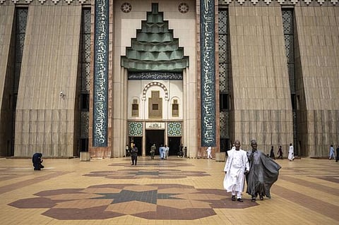 Muslim worshippers walk out of Abuja National Mosque after attending the Friday prayers in Abuja, Nigeria.