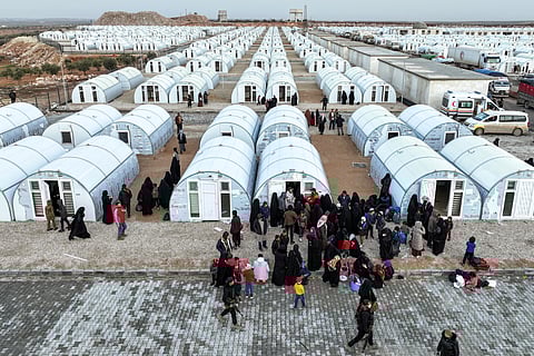 PEOPLE arrive from the Al-Hol camp in eastern Syria by the new tent shelters at the Akbaran camp near Akhtarin, in the north of Aleppo province, on 17 February 2026. Syria began evacuating remaining residents of Al-Hol camp, which long housed relatives of suspected Islamic State group fighters, as it empties the formerly Kurdish-controlled facility, two officials told Agence France-Presse. Al-Hol was taken over by government forces from its Kurdish administrators.
