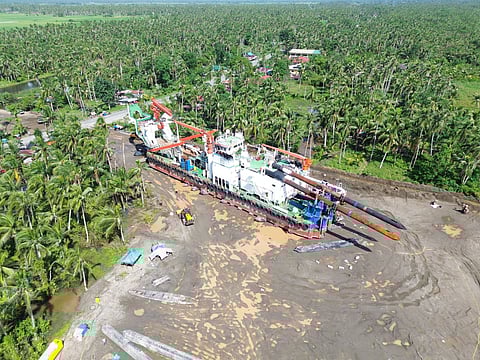THE enormous cutter suction dredger MV Li Long inches its to the national highway on its way to the mining site. MIPC, the mining company, says it will withdraw the equipment due to the mounting opposition from various groups.