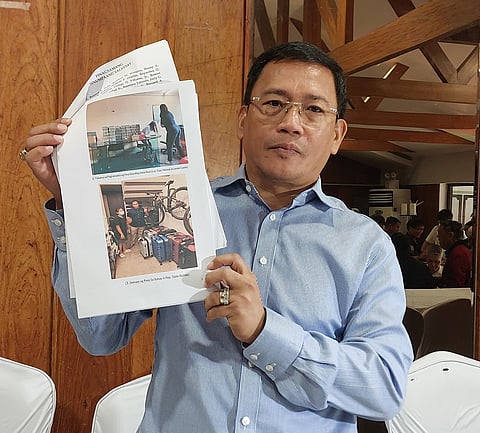 Atty. Levito "Levi" Baligod holding papers containing the alleged delivery of suitcases and bags of money to various politicians and International Criminal Court investigators at Club Filipino in San Juan this Tuesday.