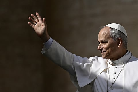Pope Leo XIV waves to the crowd during the weekly general audience at St Peter's Square in The Vatican on 18 February 2026. Pope Leo XIV will make a one-day visit to the principality of Monaco on 28 March 2026 and will take a tour of four African countries from 13 to 23 April: Algeria, Cameroon, Angola and Equatorial Guinea, the Vatican announced on 25 February 2026.
