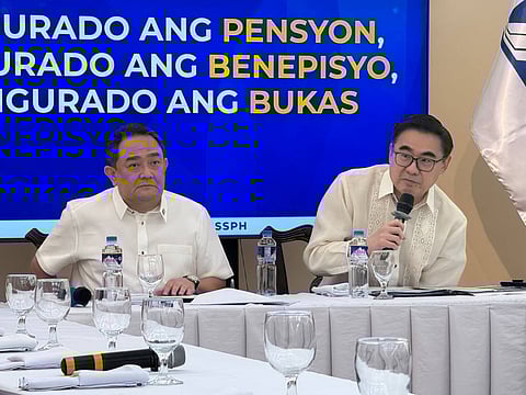 SSS President and CEO Robert Joseph de Claro (left) and DOF Secretary Frederick Go speak at a press conference at the SSS headquarters in Quezon City on Thursday, 26 February.