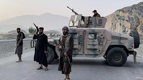 TALIBAN security personnel stand guard near the Torkham border crossing between Afghanistan and Pakistan in the Nangarhar province