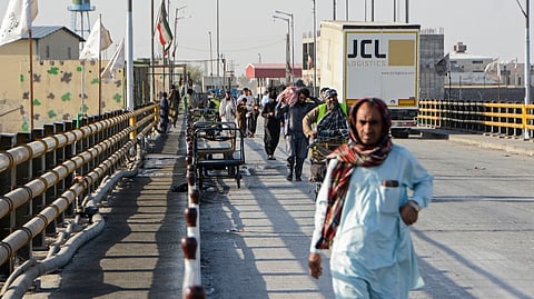 AFGHAN returnees walk upon their arrival from Iran after the Pul-e Abresham or the Silk Bridge zero-point border crossing between Afghanistan and Iran closed, at Zaranj in Nimruz province on 28 February 2026.