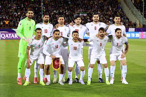 Iran's national footbal team pose for a group picture before the FIFA World Cup 2026 Asia zone qualifiers group A football match between Iran and Uzbekistan, on March 25, 2025 in Tehran. The war in the Middle East triggered by US and Israeli strikes on Iran has raised the question of whether the Iranian national team will take part in the 2026 World Cup, during which it is due to play group games in the United States.