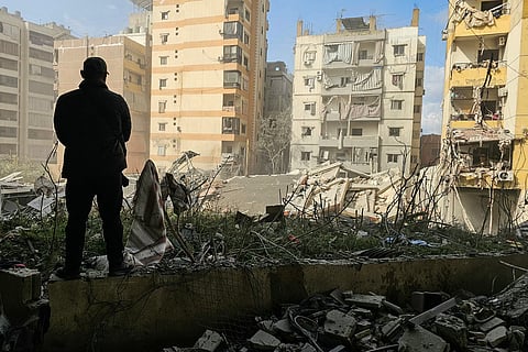 A man looks at the damage at the site of an Israeli airstrike that targeted the Al Lailaki neighbourhood in Beirut’s southern suburbs on March 4, 2026. Israel launched fresh strikes on Iran and Lebanon, where state media reported a residential building was hit on March 4, as Iran's Guards said they had sealed off one of the world's most vital shipping routes for energy.