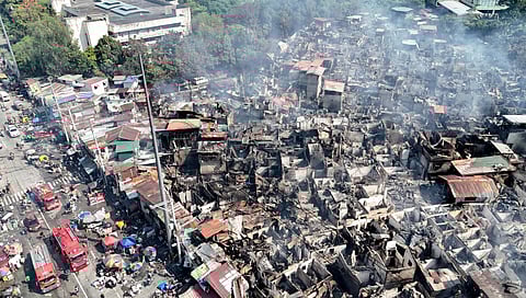 RESIDENTS sift through the charred remains of their homes, salvaging what little can still be reused after a massive fire gutted about 95 percent of a residential area in Barangay Pinyahan, Quezon City on Saturday.