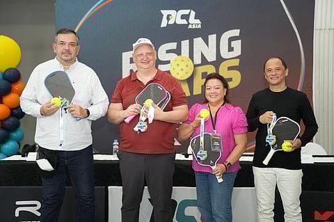 PCL Asia founder Steve Kuhn (second from left) holds a paddle and pickleball with (from left) Kosmas operations director Richard Bachmann, head referee Gigi Maceda, and tournament director Cesar Guinto during the launch of the Kosmas Pickle Fest 2026 in Cebu City on Tuesday.