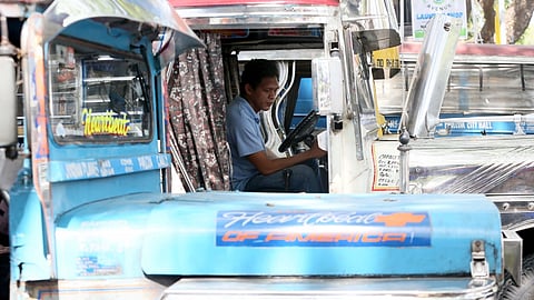 DRIVERS of traditional jeepneys seen prepping while waiting for their designated trips at a terminal in Quezon City on Wednesday.