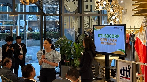 TRADE Secretary Cristina A. Roque (center, holding a microphone) awards beneficiaries of the Women’s Enterprise Fund during the launch of the OFW Negosyo Fund and Export Business Expansion Financing at the DTI MSME Hub in Makati City on Wednesday, 11 March.
