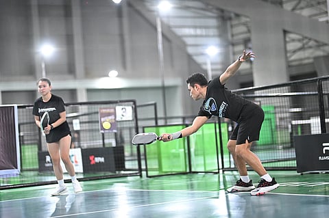 CLINT Ontal reaches out for a return as teammate Jeanette Eduave looks on during their gold medal match against Patrick Laput and Abe Tomoti in mixed doubles 20+ division of the High Intermediate event of the Kosmas Pickle Fest 2026 in Cebu City.