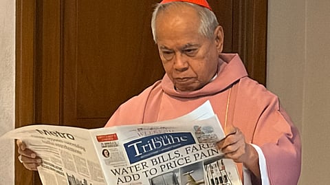 Cardinal Orlando B. Quevedo, OMI, curiously flips through the pages of DAILY TRIBUNE before leading his birthday thanksgiving Mass.