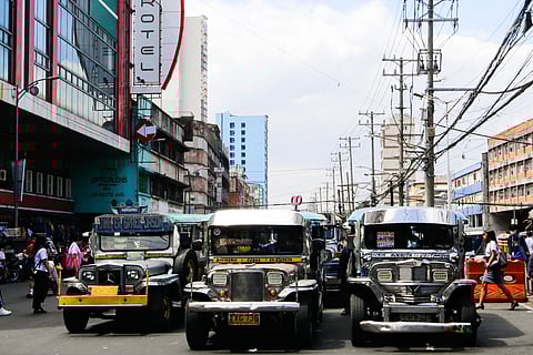 Public Utility Jeepneys (PUJs) ply their route at Recto Avenue in Manila on 16 March 2026. The Land Transportation Franchising and Regulatory Board (LTFRB) recently approved a fare hike in Metro Manila to assist drivers struggling with surging fuel costs, as diesel prices are projected to exceed P100 per liter this week.