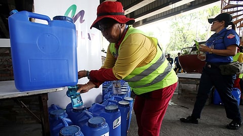 A STREET sweeper takes a breather as she check on the water gallons provided by the Metropolitan Manila Development Authority. The MMDA is reactivating the heatstroke break for street sweepers and traffic enforcers.
