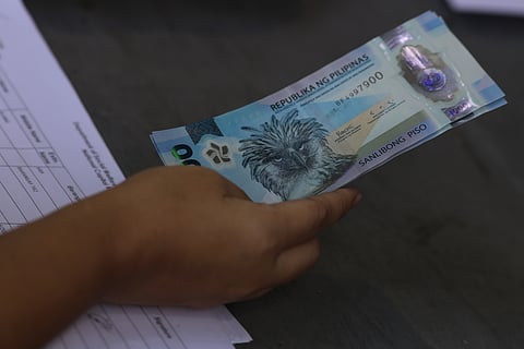 Tricycle drivers receive ₱5,000 in cash assistance during a DSWD payout at the Dakota Covered Court in Ermita, Manila last March 16.
