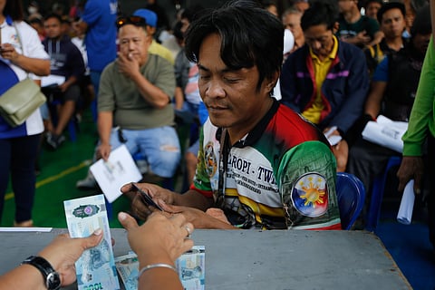 Tricycle drivers receive ₱5,000 in cash assistance during a DSWD payout at the Dakota Covered Court in Ermita, Manila, on 16 March 2026. The site is one of 30 locations identified by the Department of Social Welfare and Development across the National Capital Region to facilitate the distribution.