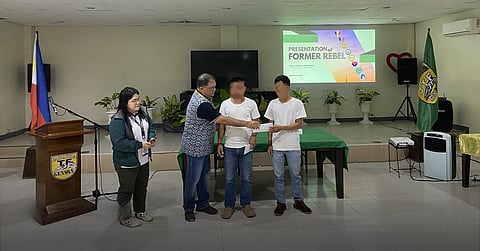 TWO CTG members from Team B, Platoon Brigol of the dismantled Guerrilla Front 73 (GF Musa) surrender to government forces at Task Force Barracuda headquarters in Barangay Bula, General Santos City on 14 March, turning over two M1 Carbine rifles with magazines.