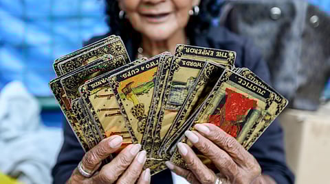 Betty Mayo, 75, showing her tarot cards at Plaza Miranda, Manila.