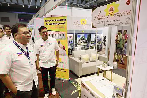 DHSUD Secretary Jose Ramon Aliling inspects housing exhibits during the Housing Fair 2026 Central Luzon at the LausGroup Event Center in Pampanga, highlighting available units under the Expanded 4PH Program.