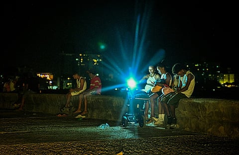 People gather at the Malecon waterfront during a blackout in Havana on March 16, 2026. Cuba suffered a widespread power cut on 16 March 2026, according to the national electricity company, against the backdrop of a severe crisis on the island caused by the US energy blockade.
