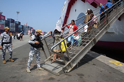 PERSONNEL from the Philippine Coast Guard assist passengers off a vessel at a port. The PCG is gearing up for the observance of the Holy Week.
