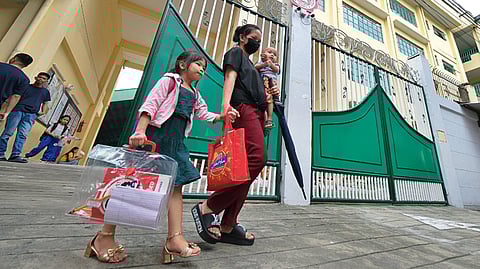 A MOTHER is fetching her daughter from the Epifanio delos Santos Elementary School along Tramo Street in Pasay City, which comes after President Ferdinand Marcos Jr. approved the three-term academic calendar for public schools.