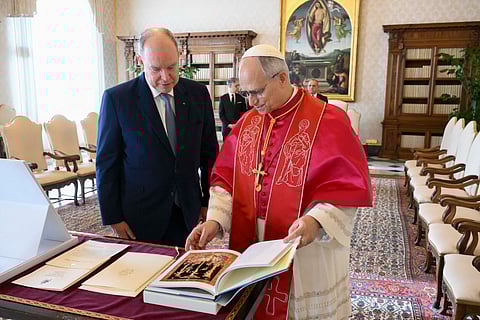 This photo taken and handout on January 17, 2026 by The Vatican Media shows Pope Leo XIV exchanging gifts with Prince Albert II of Monaco during their meeting in The Vatican.