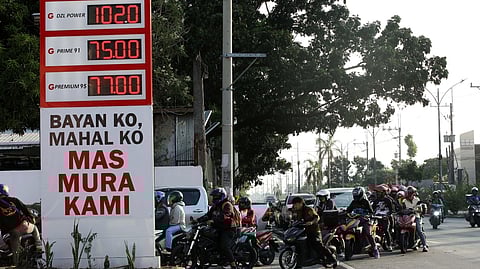 MOTORISTS queue up to refuel at PetroGazz Station along Mindanao Extension in Quezon City on Saturday as the gas station displays a large tarpaulin with the sign ‘Bayan Ko Mahal Ko Mas Mura Kami.’