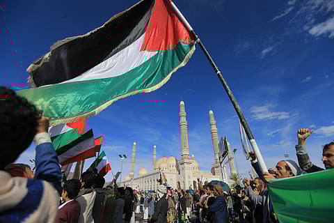 A Palestinian flag is raised as Houthis rally in solidarity with Iran and Lebanon, amid the US-Israeli war with Iran, in the Yemeni capital Sanaa on March 27, 2026.
Abdul Malik al-Houthi, leader of Yemen's Iran-backed Houthi movement, warned on March 26 of a "military response" should the Middle East war require it. The Houthis, a key part of Iran's so-called "axis of resistance", have so far refrained from joining the war sparked by US-Israeli strikes on Iran, which has engulfed much of the region.