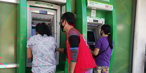 MEMBERS of the Department of Social Welfare and Development's Pantawid Pamilyang Pilipino Program withdrawing her cash grant through her cash card.