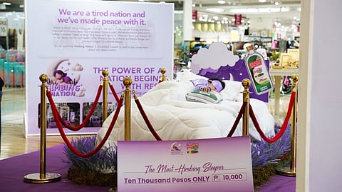 A PARTICIPANT lies in a staged bedroom installation during the Himbing Nation exhibit in Cebu, highlighting the importance of rest and sleep as part of World Sleep Day.