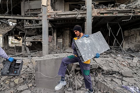 A MAN retrieves computer servers and equipment from an office building that housed the offices of the Doha-headquartered news network Al Araby TV following a missile strike earlier in the day in Tehran on 29 March 2026.