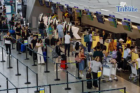 Passengers queue at airline counters at the Ninoy Aquino International Airport Terminal 3, in Pasay City on Tuesday, 31 March 2026. The oil crisis caused by the ongoing war in the Middle East has caused the airfare rates to jump up in price, forcing many Filipinos to ditch going home for the holiday season.