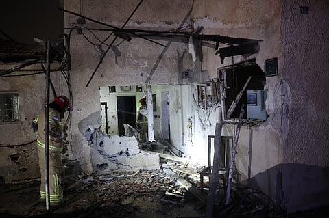 Israeli security forces and first responders gather at the site of an Iranian strike that hit a residential building in Rosh HaAyin, Israel, on 4 April 2026.