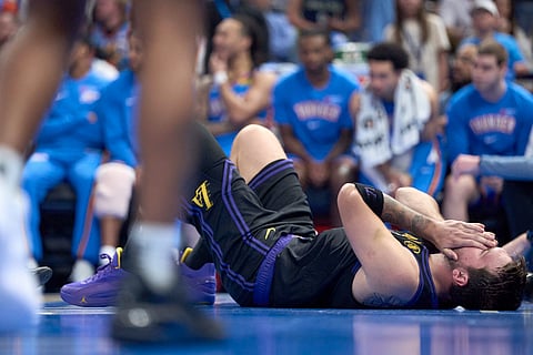 LUKA Doncic of the Los Angeles Lakers grimaces in pain after suffering a hamstring strain that will keep him out of the remainder of the NBA season.