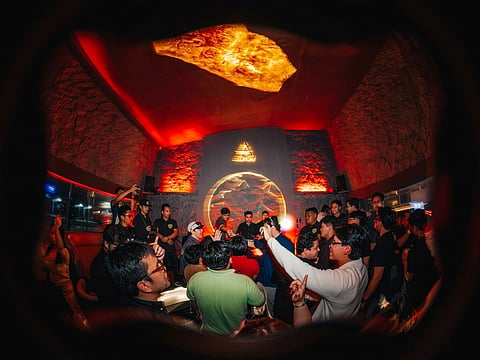 PARTYGOES gather around the DJ booth as Up North Sounds transforms the space into a high-energy, immersive nightlife experience.
