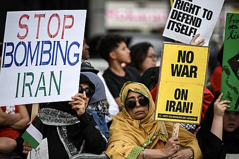 Protestors rally against US military action in Iran during a demonstration in Houston, Texas, on 7 April 2026. US President Donald Trump warned that "a whole civilization will die" in Iran if the country does not heed his midnight cutoff to open the Strait of Hormuz, as Tehran reported US-Israeli attacks on its infrastructure were already underway.