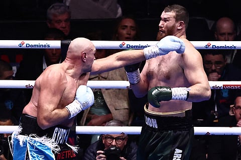 TYSON Fury (left) throws a punch at Arslanbek Makhmudov during their heavyweight 'Clash of the Giants' contest at the Tottenham Hotspur Stadium in London.