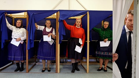 WOMEN in traditional Hungarian dresses fill out their ballot papers at a polling station in a nursery school in Veresegyhaz, some 30 kilometers east of Budapest, on 12 April 2026, during the general election in Hungary. Peter Magyar (right), leader of the pro-European conservative TISZA party, leaves a voting booth at a polling station set up in a kindergarten in Budapest.