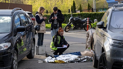 POLICE experts examine a body of a person shot by a gunman outside a supermarket in Kyiv on 18 April 2026.