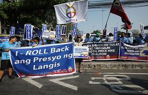 MILITANT groups gather at Philcoa along Commonwealth Avenue in Quezon City on Tuesday to protest rising fuel prices.