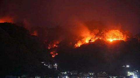 RESIDENTS and authorities remain on alert as a fire rages down the mountainside on the night of 19 April in Barangay Samoki, Bontoc, Mountain Province.