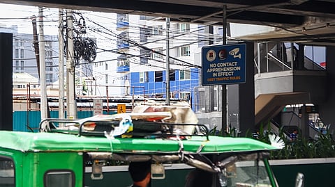 MOTORISTS drive past a sign reminding the public of the No-Contact Apprehension Policy along Taft Avenue in Manila on Wednesday.