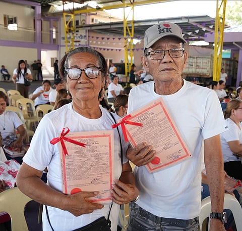 Two ARBs show off their CLOAs during the awarding of land certificates in Floridablanca, Pampanga on April 23, 2026.